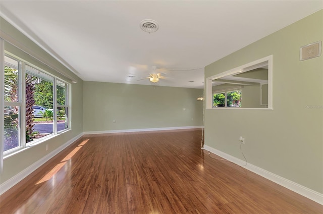 unfurnished room with hardwood / wood-style flooring and ceiling fan