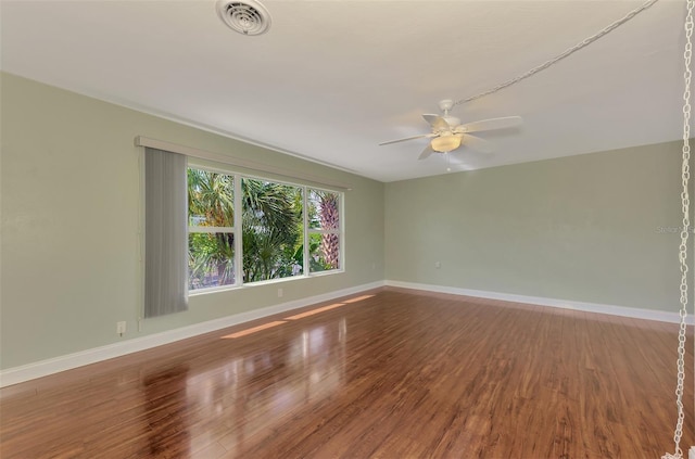 spare room with hardwood / wood-style floors and ceiling fan