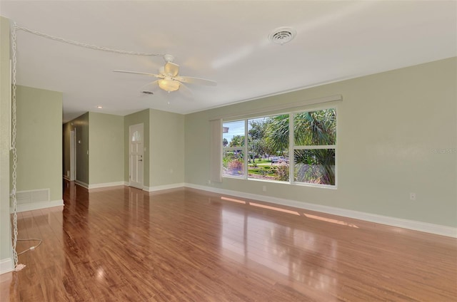 unfurnished room with ceiling fan and hardwood / wood-style floors