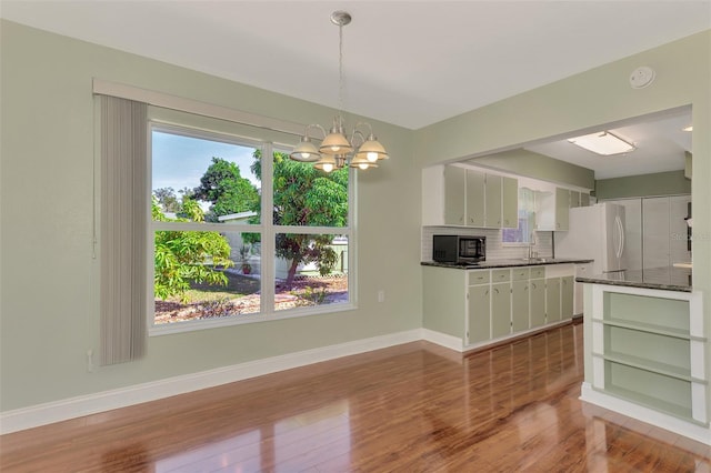 interior space featuring an inviting chandelier, hardwood / wood-style floors, and sink