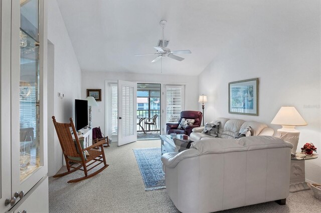 carpeted living room featuring ceiling fan and lofted ceiling