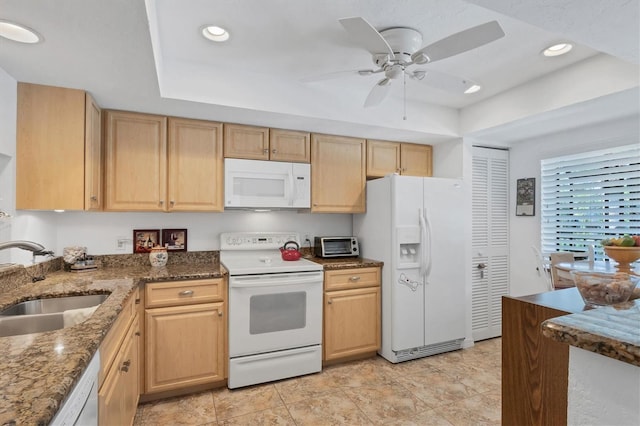 kitchen with white appliances, ceiling fan, light brown cabinets, and sink