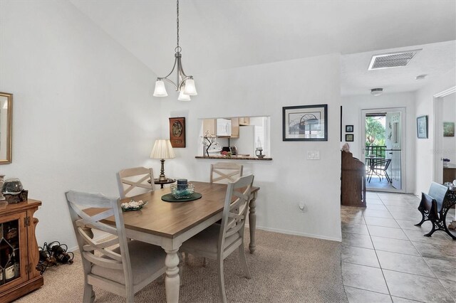 dining space featuring an inviting chandelier, vaulted ceiling, and light tile patterned floors