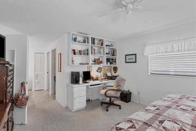 bedroom with ceiling fan, a closet, and light carpet