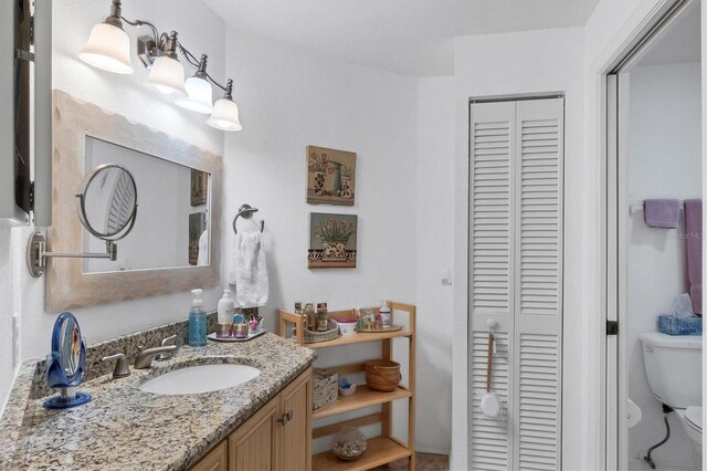 bathroom featuring vanity and toilet