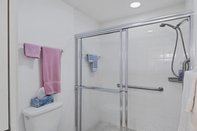 bathroom featuring walk in shower and toilet