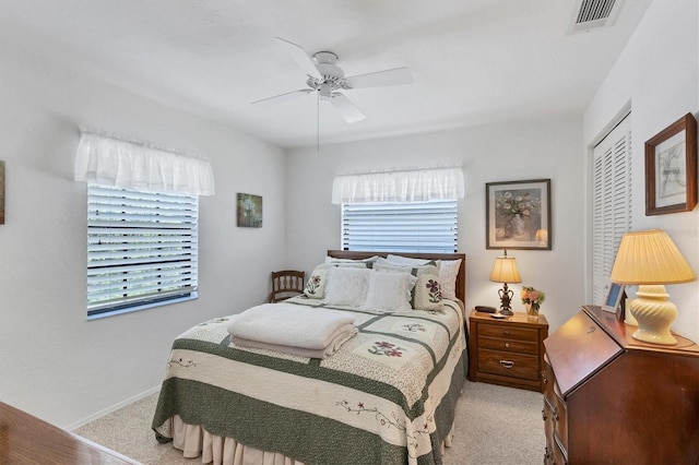 bedroom with light carpet, a closet, and ceiling fan