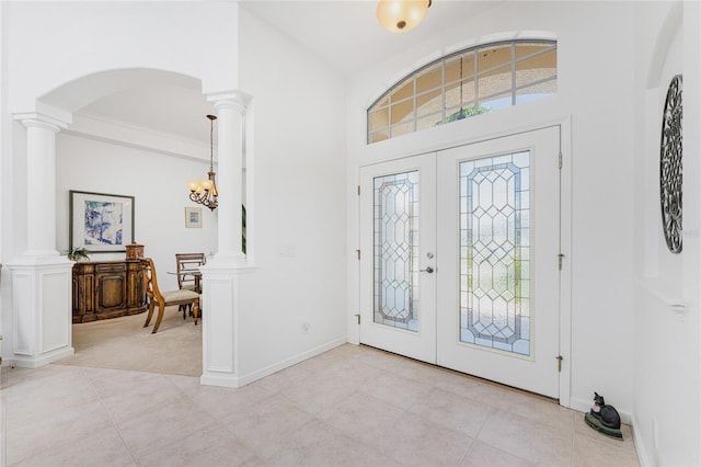 foyer featuring a healthy amount of sunlight and ornate columns