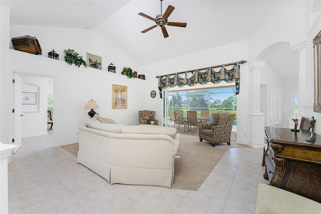 living room featuring light tile patterned floors, high vaulted ceiling, ceiling fan, and ornate columns