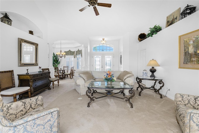 living room with light colored carpet and ceiling fan with notable chandelier