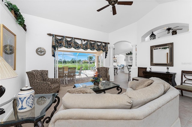 living room with ceiling fan, vaulted ceiling, tile patterned flooring, and ornate columns