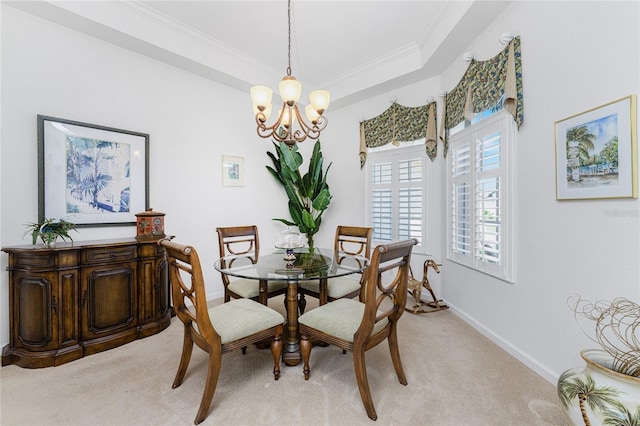 carpeted dining area with a notable chandelier and ornamental molding