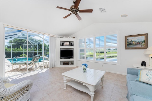 tiled living room with ceiling fan and vaulted ceiling