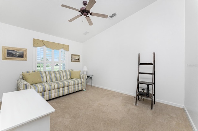 living room with lofted ceiling, ceiling fan, and light colored carpet