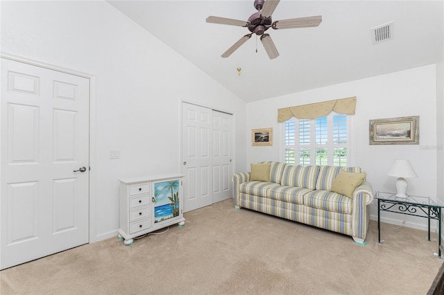 living room featuring high vaulted ceiling, ceiling fan, and light colored carpet