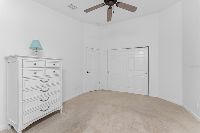 unfurnished bedroom with ceiling fan and light carpet