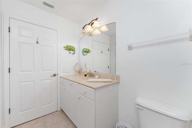 bathroom with tile patterned flooring, vanity, and toilet