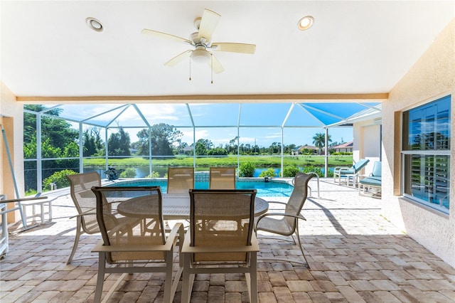 view of patio featuring glass enclosure and ceiling fan