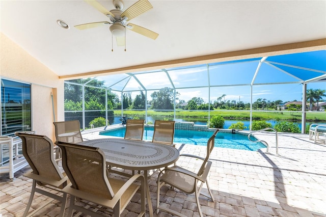 view of patio / terrace with a water view, a lanai, and ceiling fan