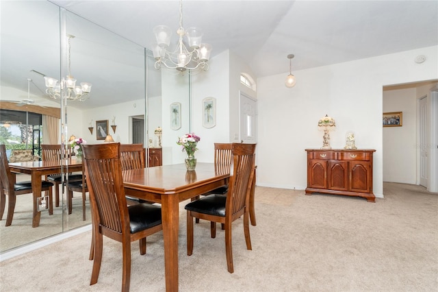 carpeted dining area with lofted ceiling and a notable chandelier