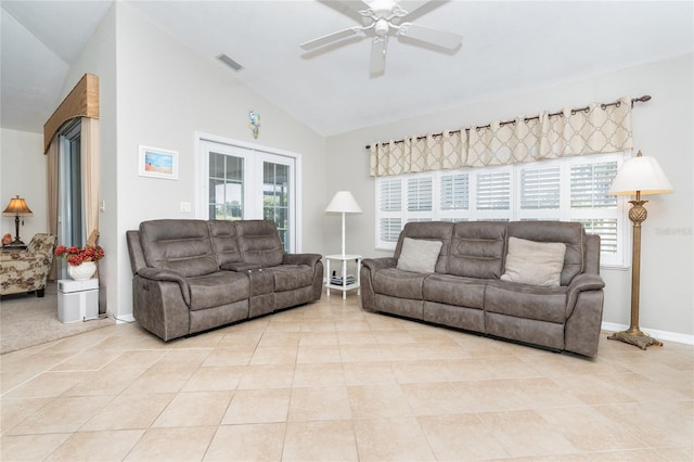 living room featuring a wealth of natural light, vaulted ceiling, ceiling fan, and light tile patterned floors