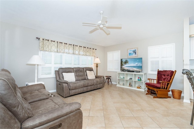 living room with ceiling fan and light tile patterned flooring