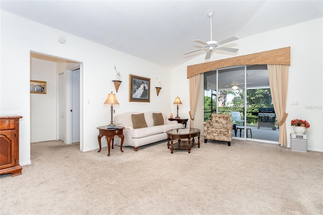 living room with lofted ceiling, light carpet, and ceiling fan