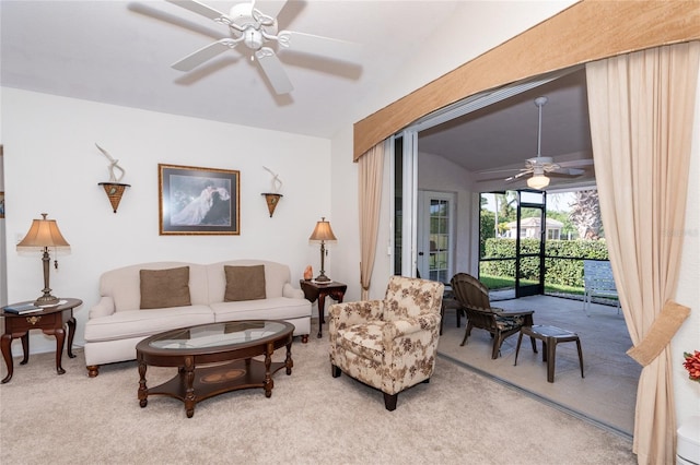 carpeted living room featuring ceiling fan and vaulted ceiling