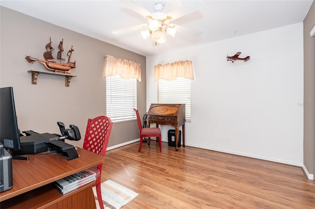 office with light hardwood / wood-style floors and ceiling fan