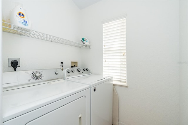 laundry area with washing machine and dryer and a healthy amount of sunlight