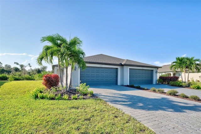 ranch-style home featuring a garage and a front lawn