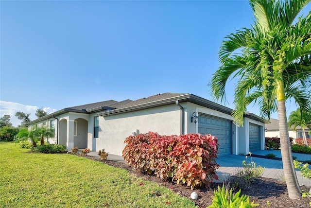 view of home's exterior with a yard and a garage