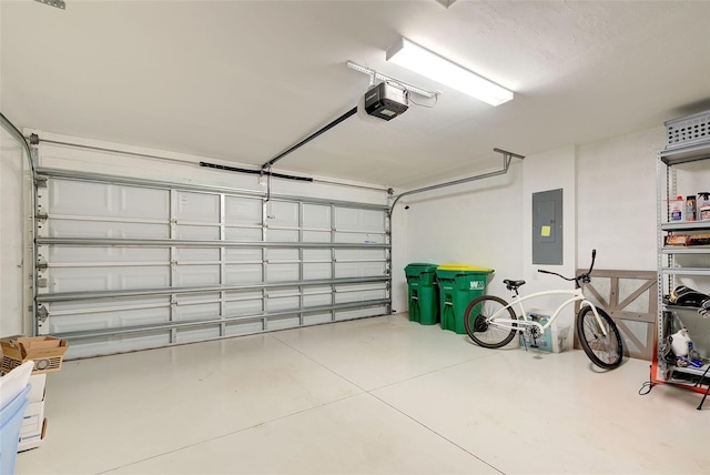 garage featuring electric panel and a garage door opener