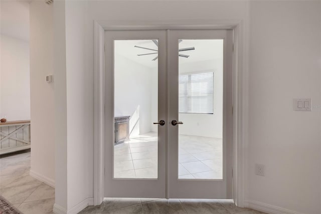 doorway to outside with french doors, light tile patterned flooring, and ceiling fan