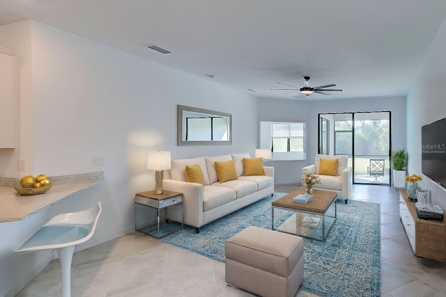 living room featuring ceiling fan and light tile patterned floors