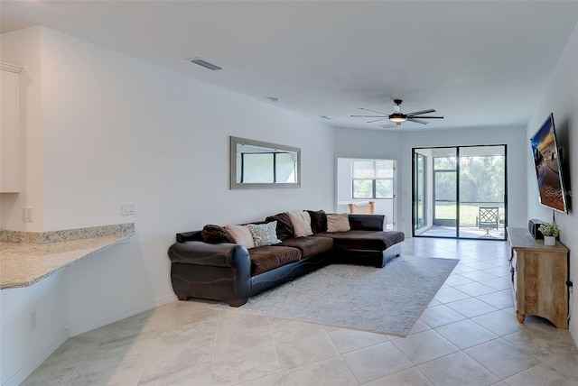 living room featuring ceiling fan and light tile patterned floors