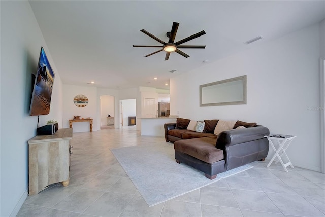 tiled living room with ceiling fan