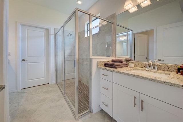 bathroom featuring vanity and a shower with shower door