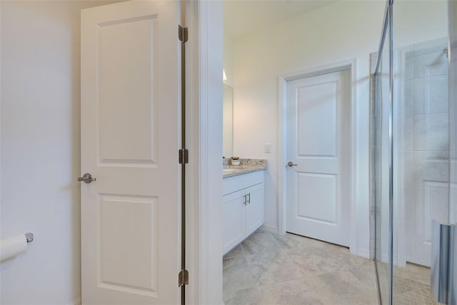 bathroom with vanity and a shower with door