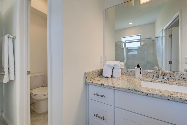 bathroom with tile patterned flooring, an enclosed shower, vanity, and toilet