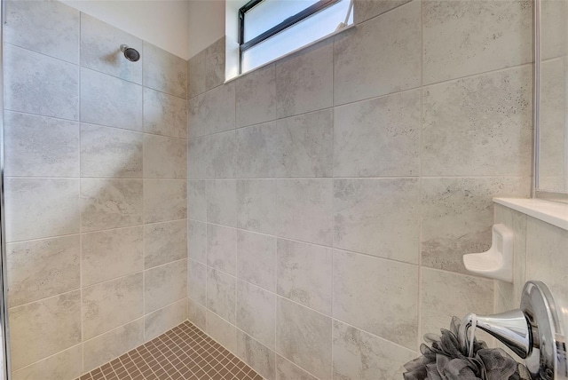 bathroom with tiled shower