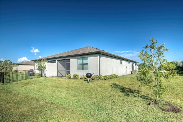 view of side of home with a lawn