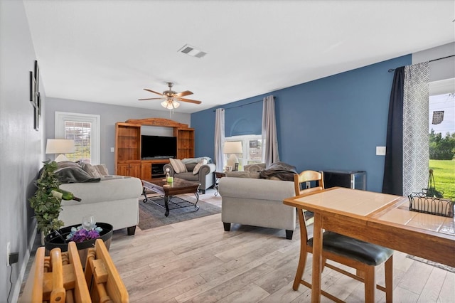 living room featuring light wood-type flooring and ceiling fan