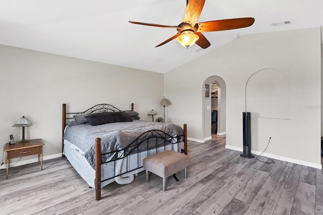 bedroom featuring ceiling fan, lofted ceiling, and light wood-type flooring