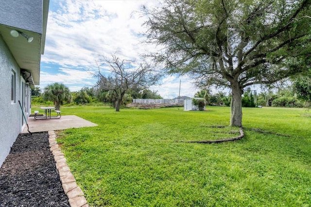 13401 Galveston Ave, Port Charlotte, FL 33981 - view of grassy yard with a patio, an outbuilding, and a storage unit
