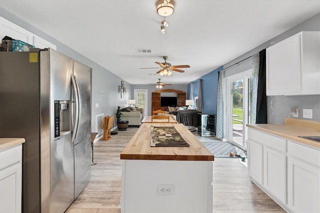 13401 Galveston Ave, Port Charlotte, FL 33981 - kitchen featuring wooden counters, stainless steel fridge, a kitchen island, light wood-style flooring, and plenty of natural light