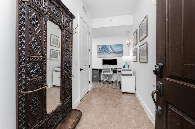 11100 Hacienda Del Mar Blvd Unit 202, Placida, FL 33946 - office area with baseboards, visible vents, built in desk, and light tile patterned floors