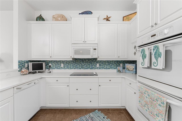 11100 Hacienda Del Mar Blvd Unit 202, Placida, FL 33946 - kitchen featuring white appliances, tasteful backsplash, dark tile patterned floors, and light countertops