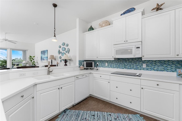 11100 Hacienda Del Mar Blvd Unit 202, Placida, FL 33946 - kitchen featuring light countertops, a sink, white appliances, decorative backsplash, and dark tile patterned flooring