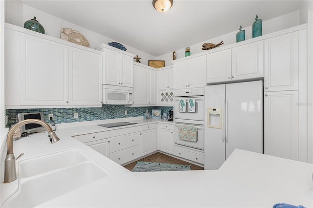 11100 Hacienda Del Mar Blvd Unit 202, Placida, FL 33946 - kitchen with light countertops, white appliances, decorative backsplash, a sink, and white cabinets
